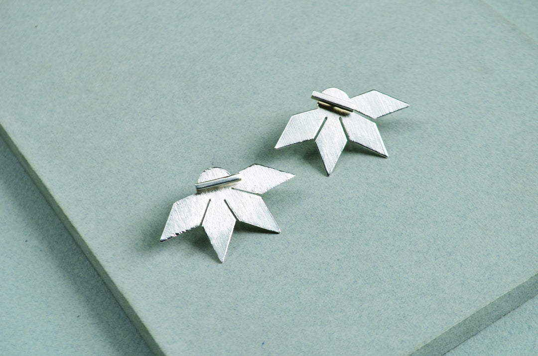 Aretes Su´usi Flor Plateada L con detalles de fabricación